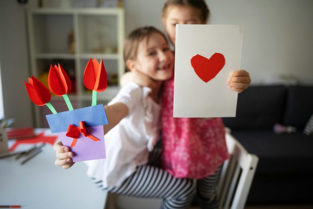 craft for kids. cards with heart and bouquet of paper flowers for mother's day, March 8 or birthday