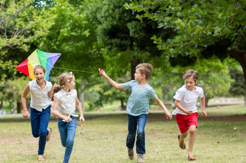 Kids playing with a kite in park
