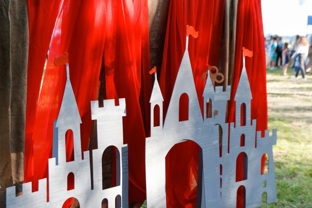 paper red castle outside. Photo of medieval decorations made of cardboard. History festival. Out of