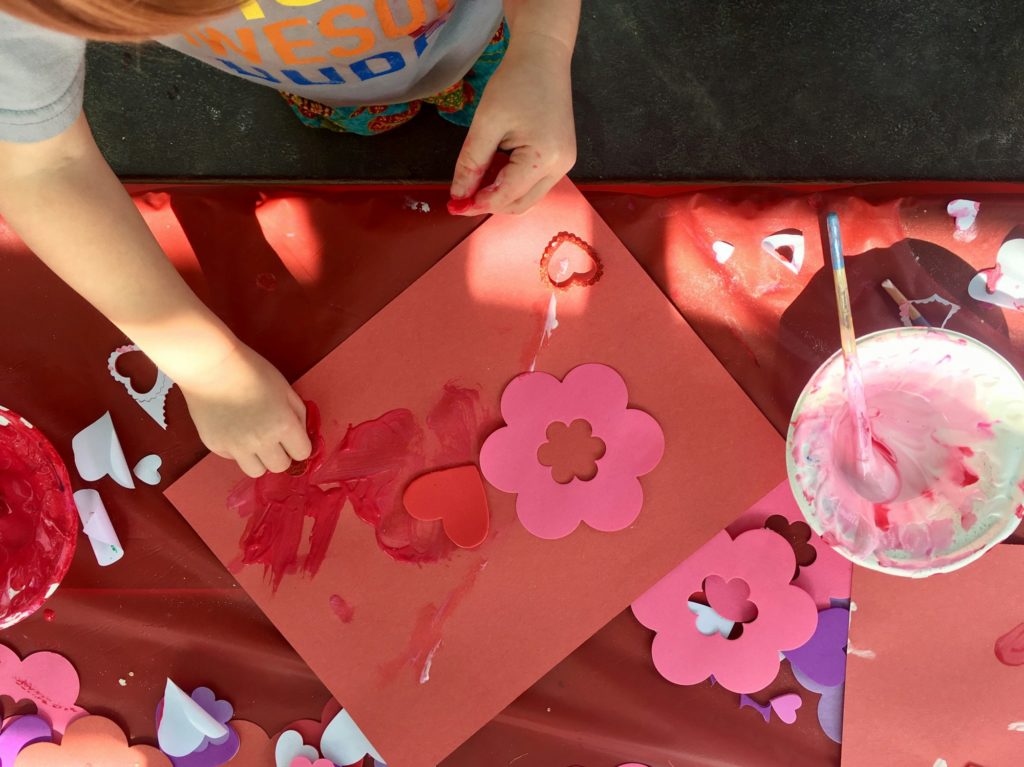 Overhead shot of toddler making Valentine's Day card